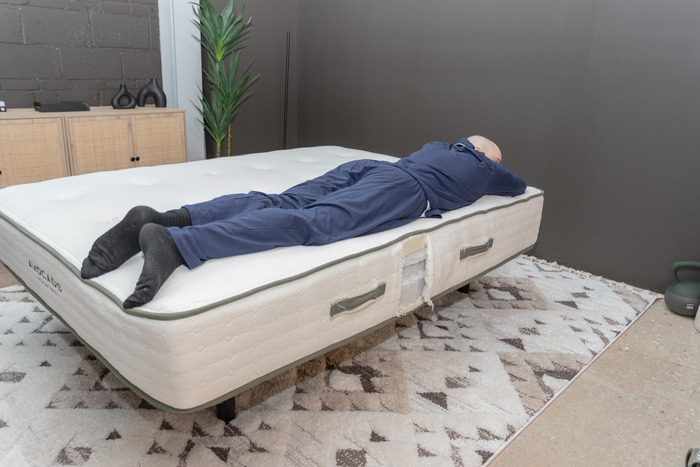 A man lying on the Avocado Green in the stomach-sleeping position.