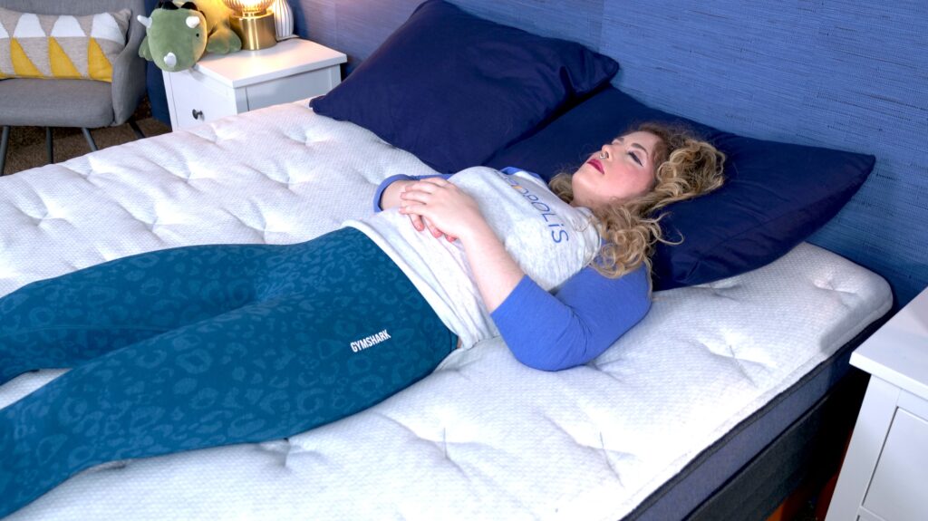 Nichole back sleeping on the Helix Midnight Luxe.