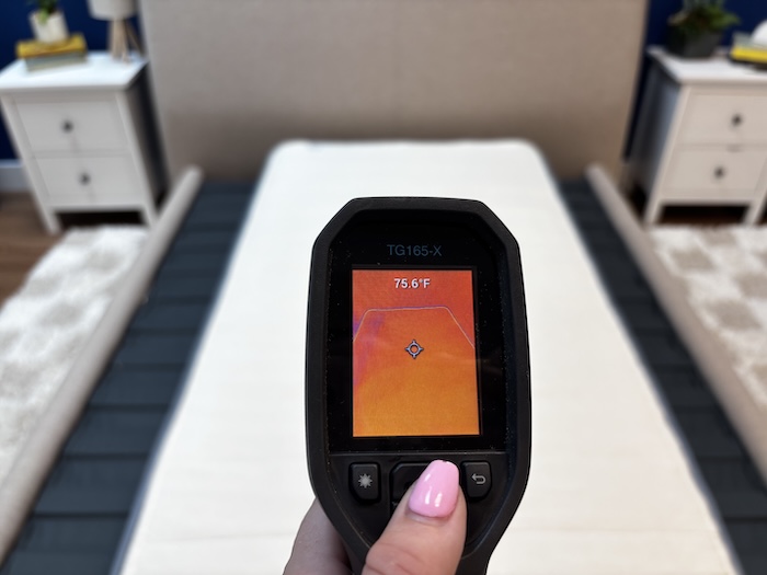 A closeup of a thermal gun reading the Birch Kids mattress's temperature. The screen displays 75.6 degrees.