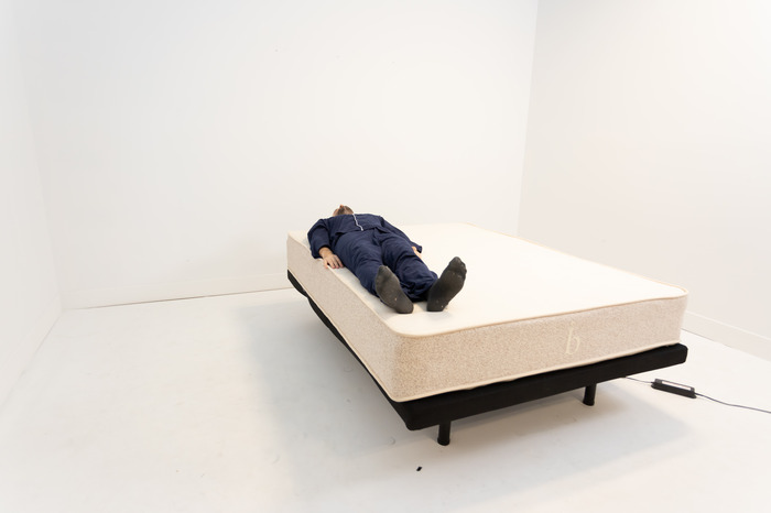 A man lying on his back on the Birch Natural mattress.