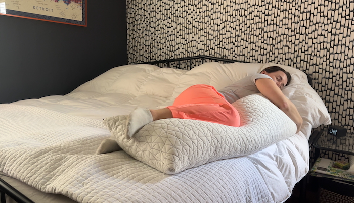 Our tester Nicole Davis hugging a Coop Body Pillow