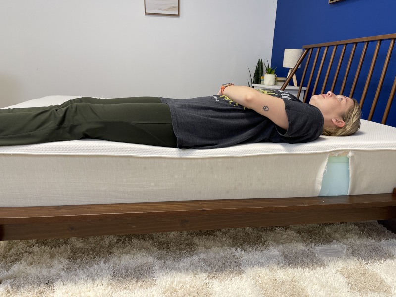 Riley Otis performs a full-body edge support test on a Boring AF Mattress