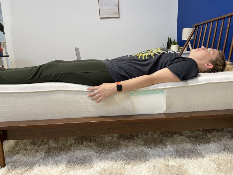 Our tester does a full-body edge support test on a Boring Hybrid Mattress.