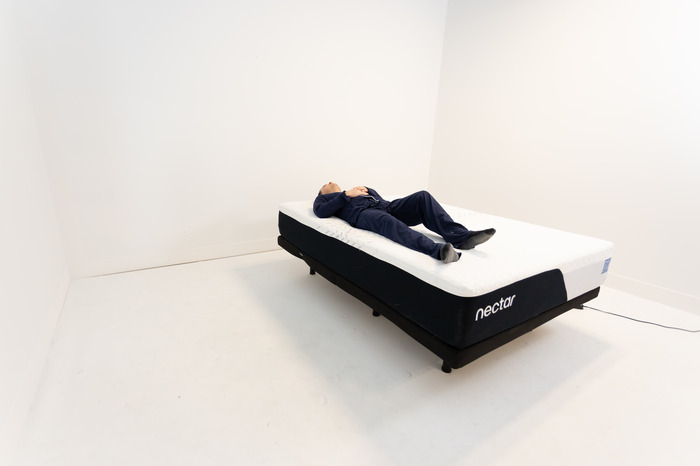 A man back sleeping on the Nectar mattress.