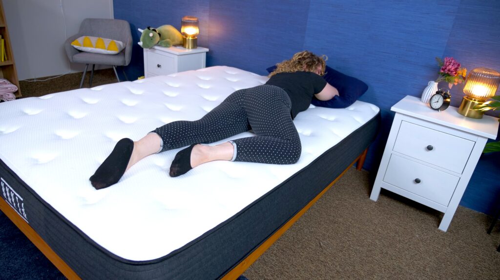 Nichole stomach sleeping on the Plank Firm Mattress