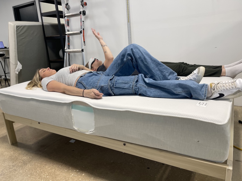 Our testers performing a partner test to evaluate the motion isolation properties of a Boring Hybrid Mattress.