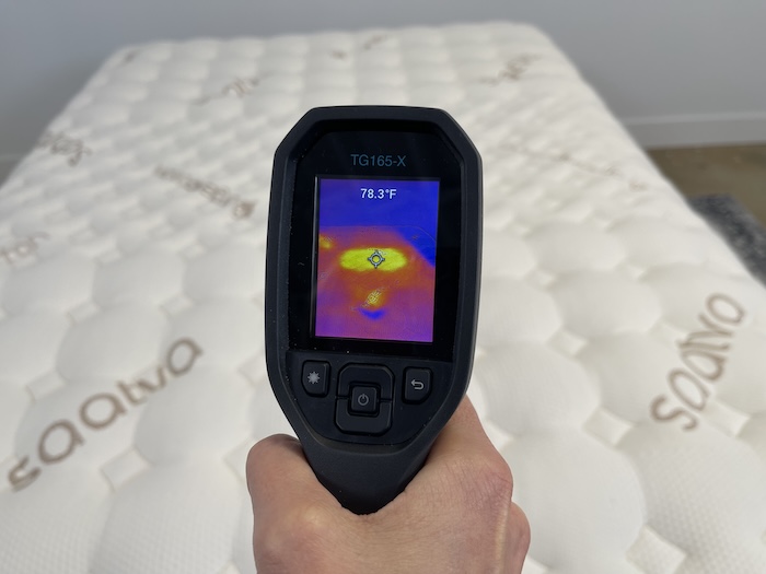 A closeup of someone using a thermal gun to take the temperature of the Saatva Rx after 5 minutes of someone lying on it. The screen reads 78.3 degrees.