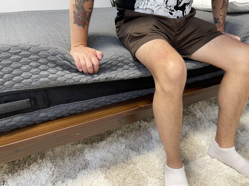 Our tester performs a seated edge support test on a Layla Signature Hybrid Mattress