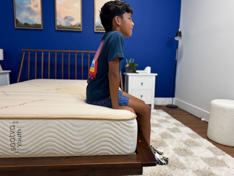 Our tester does a seated edge support test on the Saatva Youth Mattress