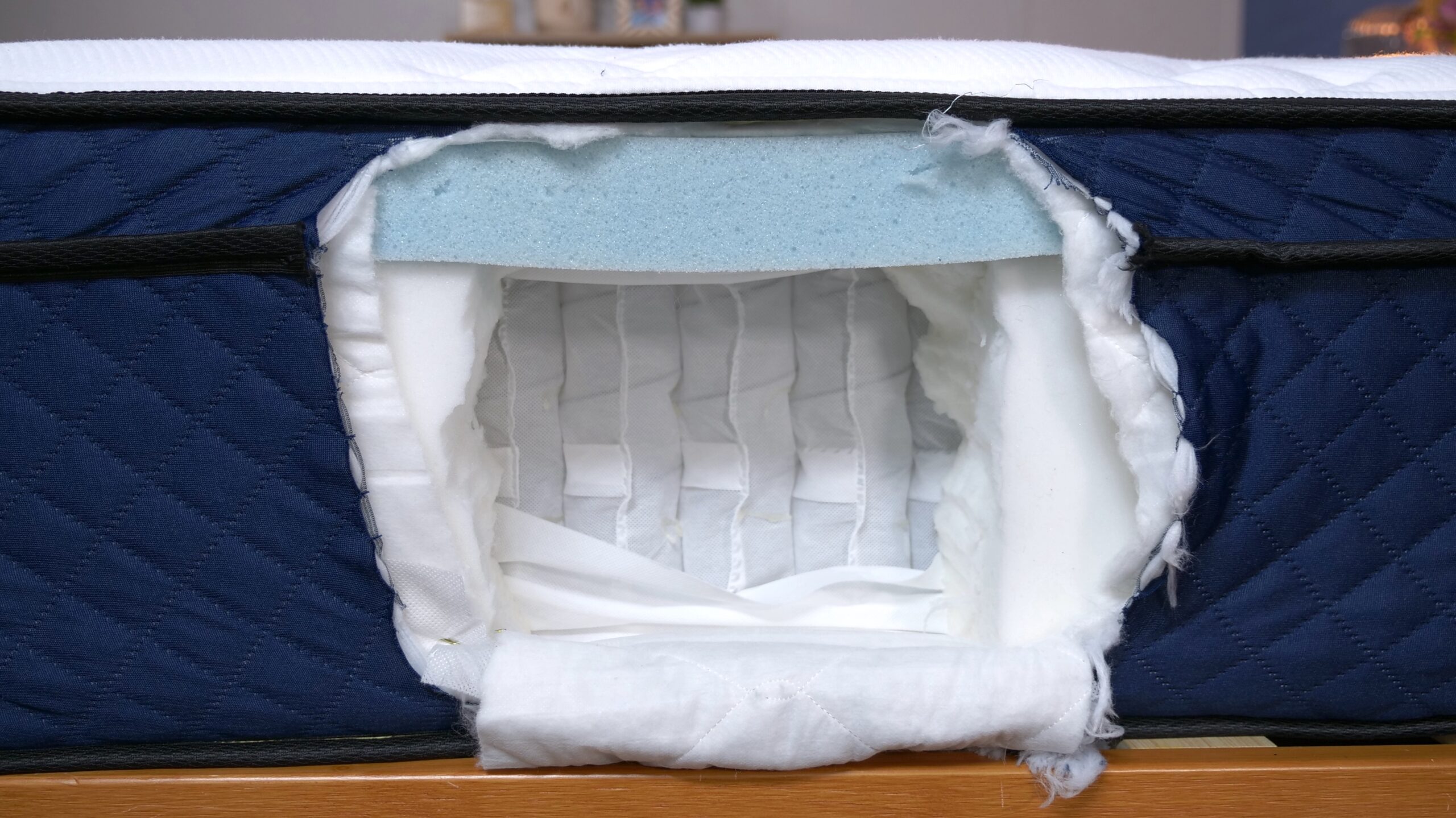 A cut-open mattress shows the interior construction of a Silk and Snow Hybrid mattress