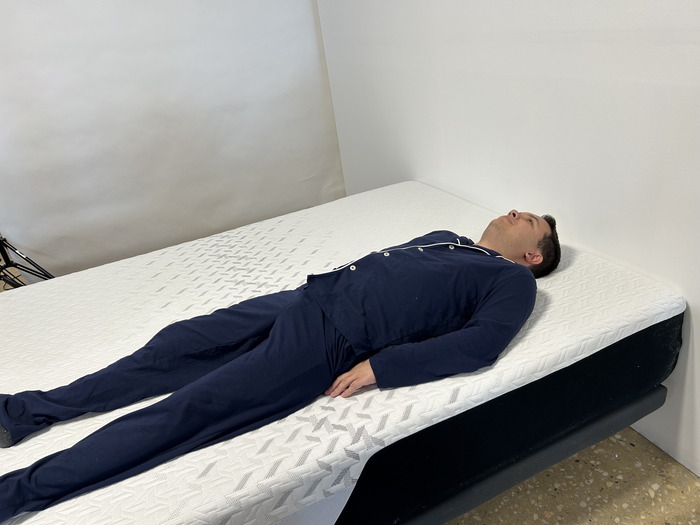 A person is shown back sleeping on the Nectar Mattress