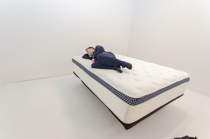 A man lying on his side on the WinkBed Plus mattress.