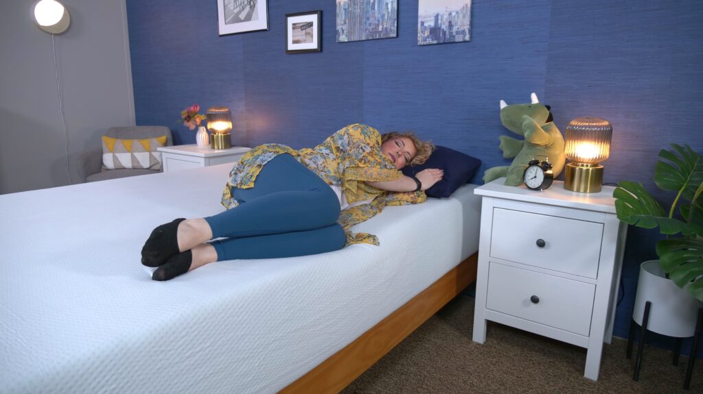 Nichole side sleeping on the Zinus Green Tea Memory Foam mattress.